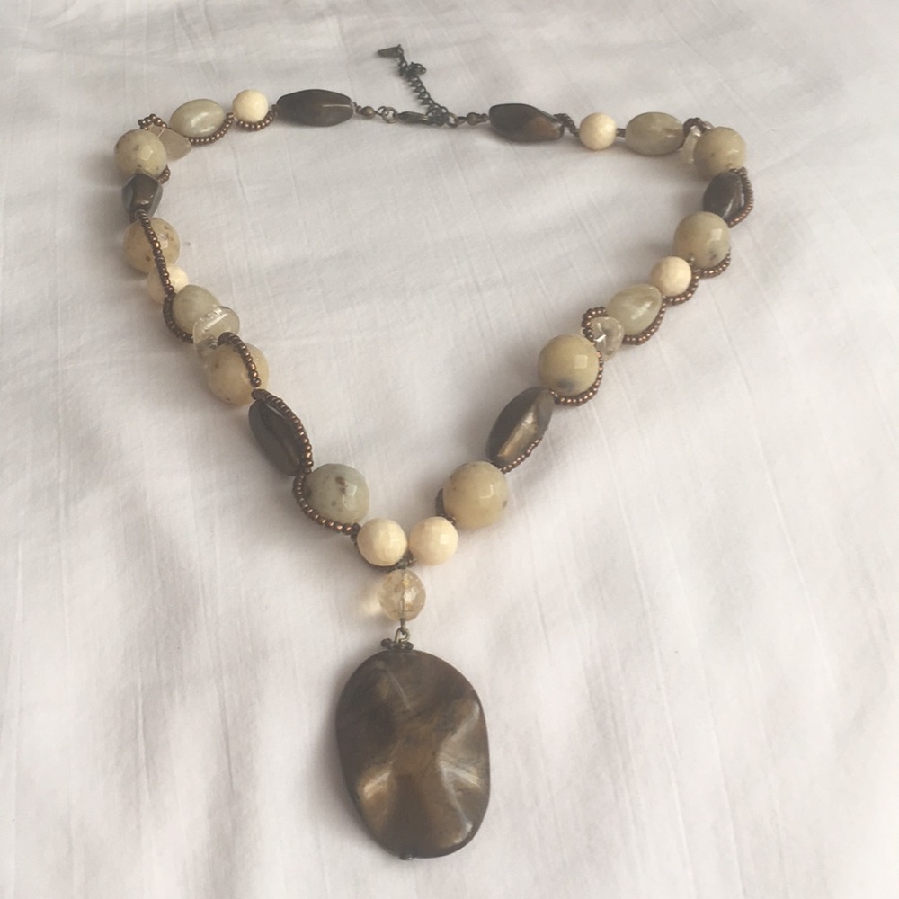 Beaded necklace with larger pendant.